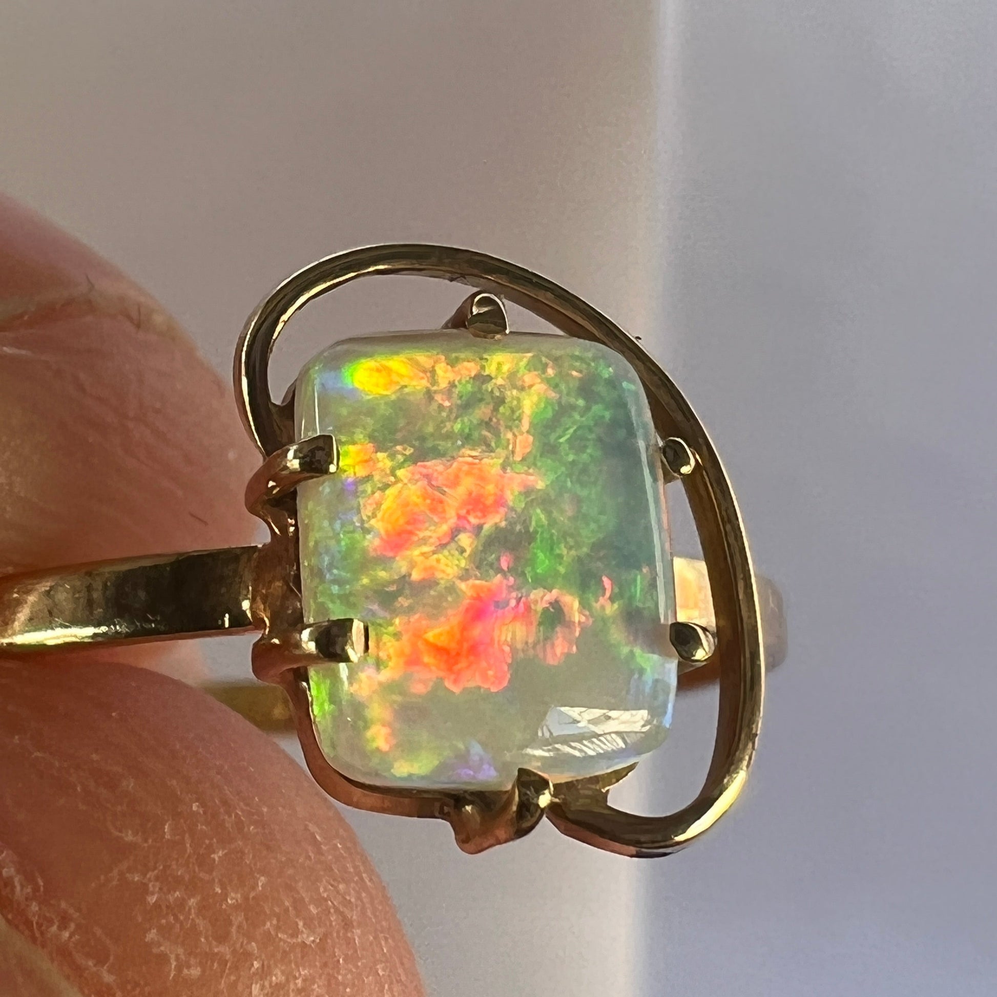 Great little one-off 14ct gold ring featuring a cushion cut Coober Pedy crystal opal. Displays breath-taking colours.