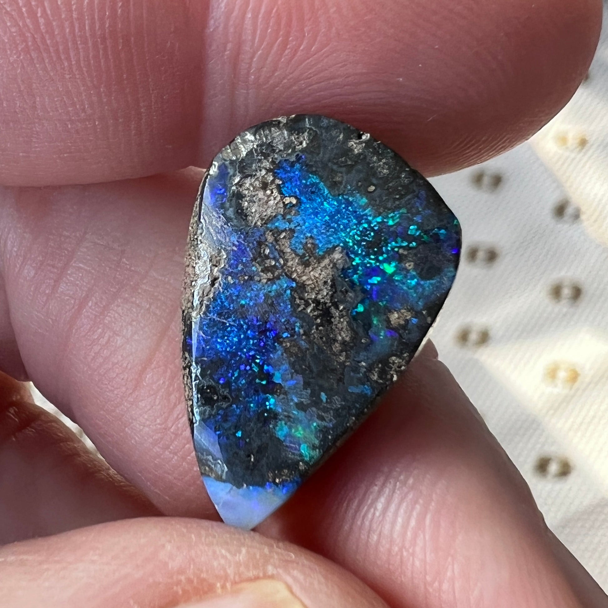 A nice 12ct Winton boulder opal displaying blues and greens. Polished and ready to set.