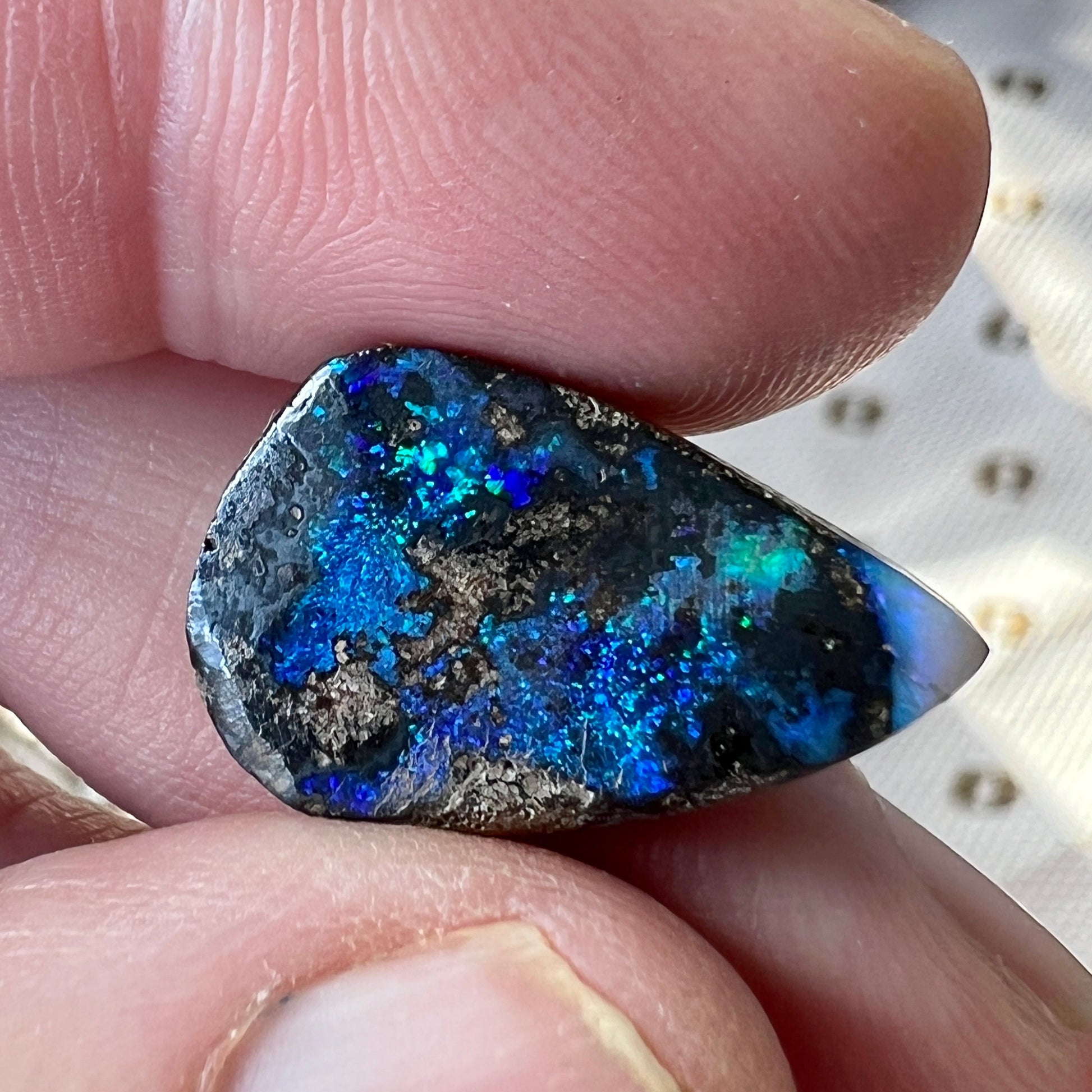 A nice 12ct Winton boulder opal displaying blues and greens. Polished and ready to set.