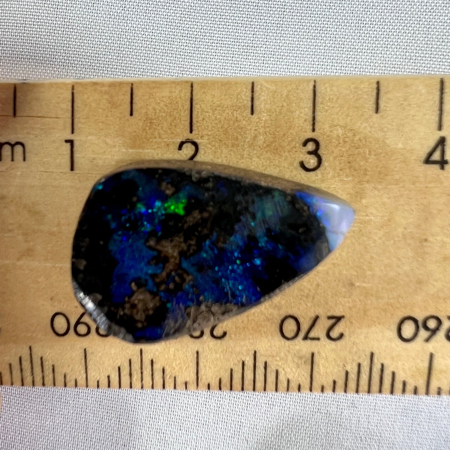 A nice 12ct Winton boulder opal displaying blues and greens. Polished and ready to set.