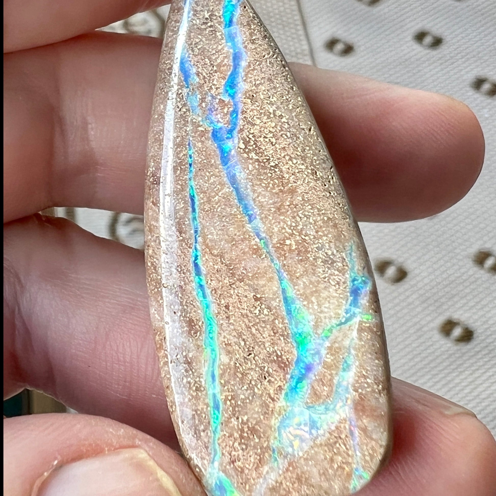 Lovely stone with aqua coloured lines throughout. Would make a statement piece pendant.