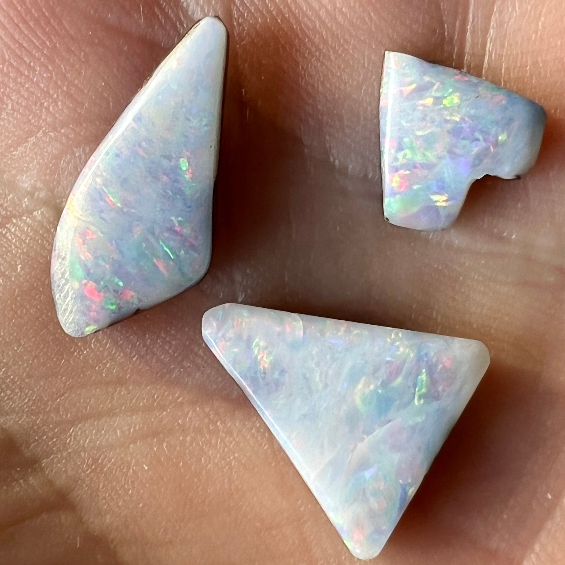 Three beautiful pieces of boulder opal from Eromanga, Queensland. Nice pin fire pattern displaying reds and greens.