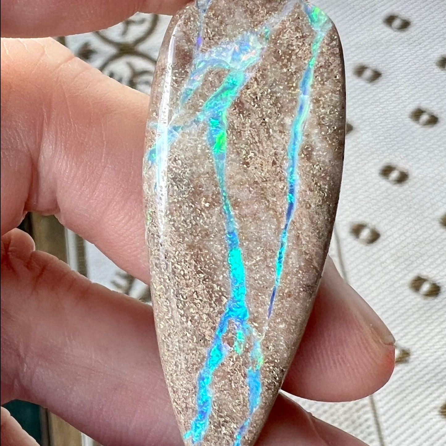 Lovely stone with aqua coloured lines throughout. Would make a statement piece pendant.