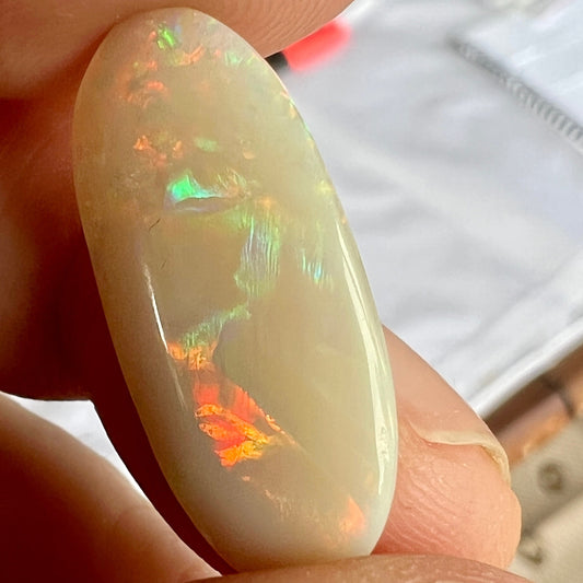 Large solid white double sided opal from Coober Pedy. A gem of a stone, showing all the colours and shapes. Perfectly polished and oval in shape.