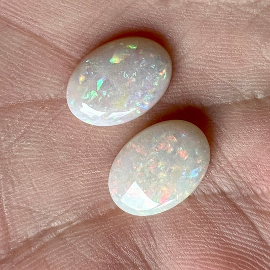 Pair of solid white opals from Coober Pedy. Cabochon cut with pin fire pattern. A matching pair would look great as earrings or anything you want.