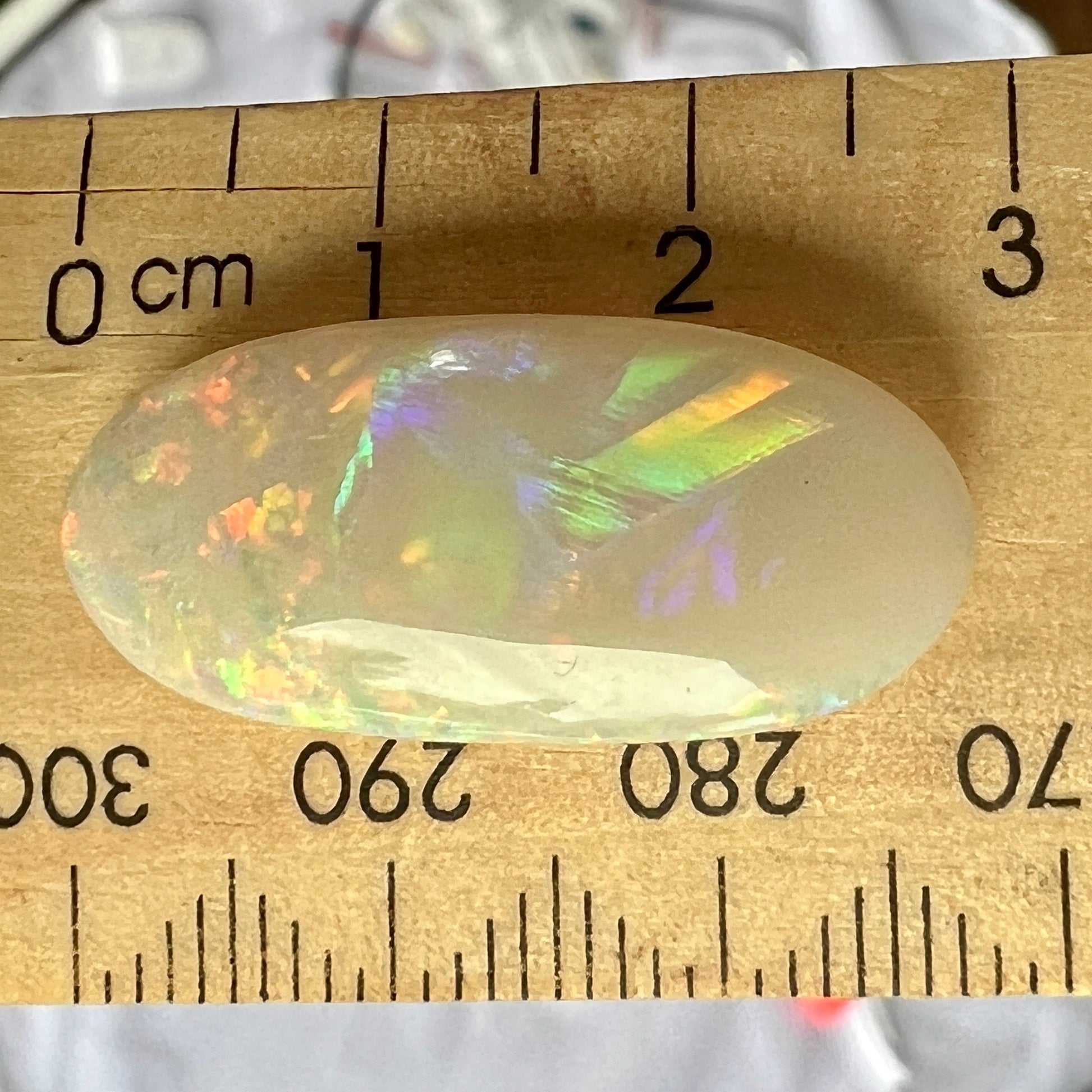 Solid white double sided opal from Coober Pedy. A gem of a stone, showing all the colours and shapes. Perfectly polished and oval in shape.