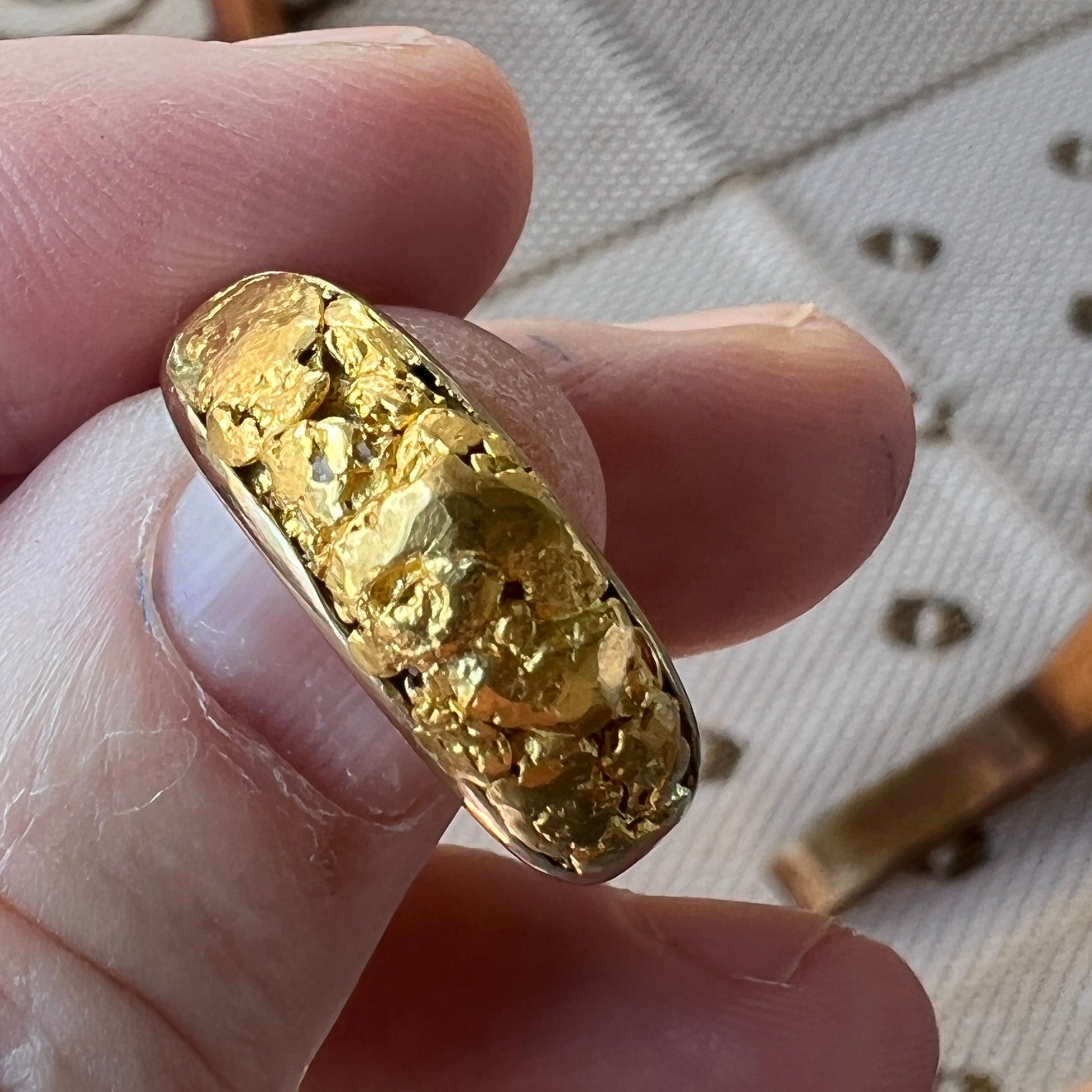 Totally unique mans handcrafted solid gold ring. Finest Australian 9ct gold filled in with genuine gold nuggets from the Victorian gold fields. Would make a unique wedding ring and has a matching ladies gold nugget ring.