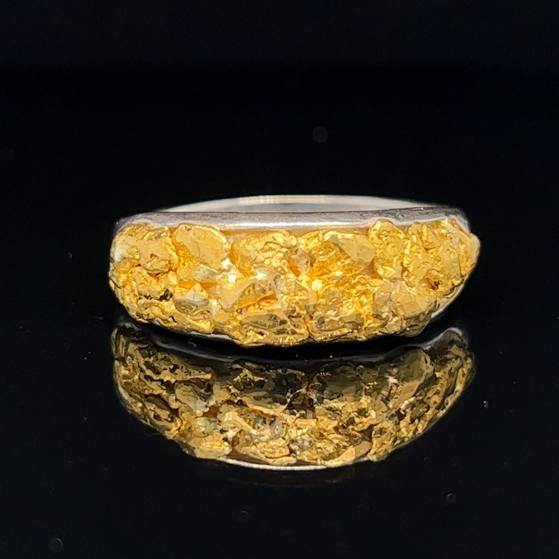 Unique hand made men's ring. Solid silver filled with pure Australian gold nuggets from the Victorian goldfields. 4.2g solid silver and 3.4g pure gold nuggets.
