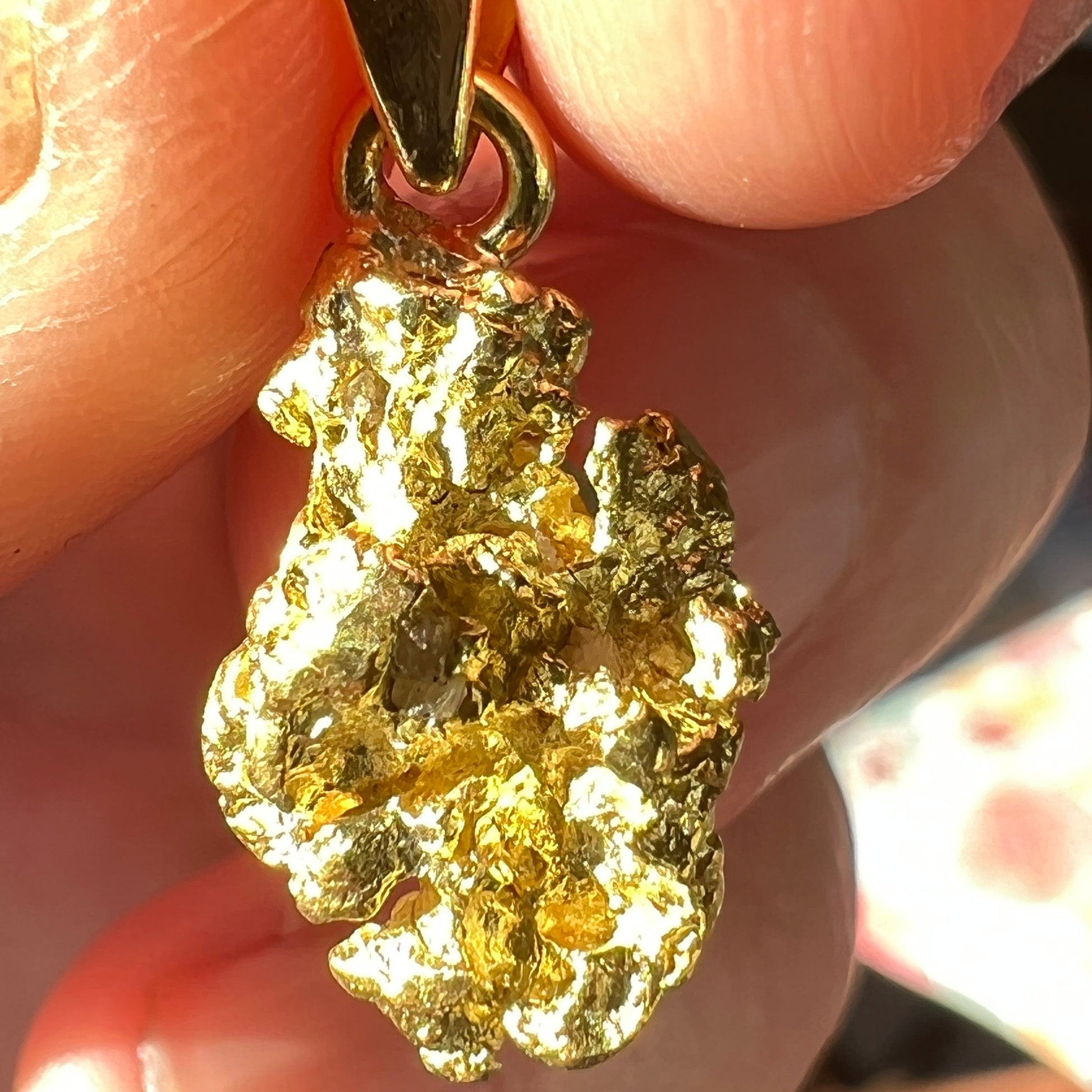 Pure gold nugget pendant from Western Australia. Perfectly set and balanced with an 18ct bale. Set with a perfectly cut solid black opal from Lightning Ridge. 