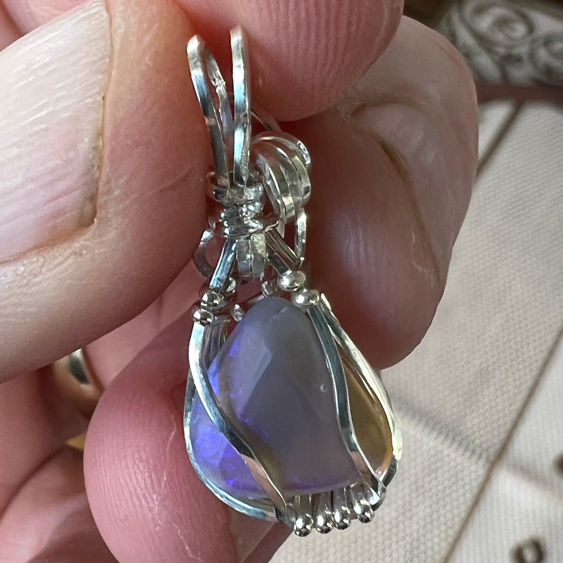 Beautifully cut Lightning Ridge Jelly Crystal opal. Cut and polished by Bill Johnson. Expertly set in a unique wire silver wrap. An awesome hand made gift.