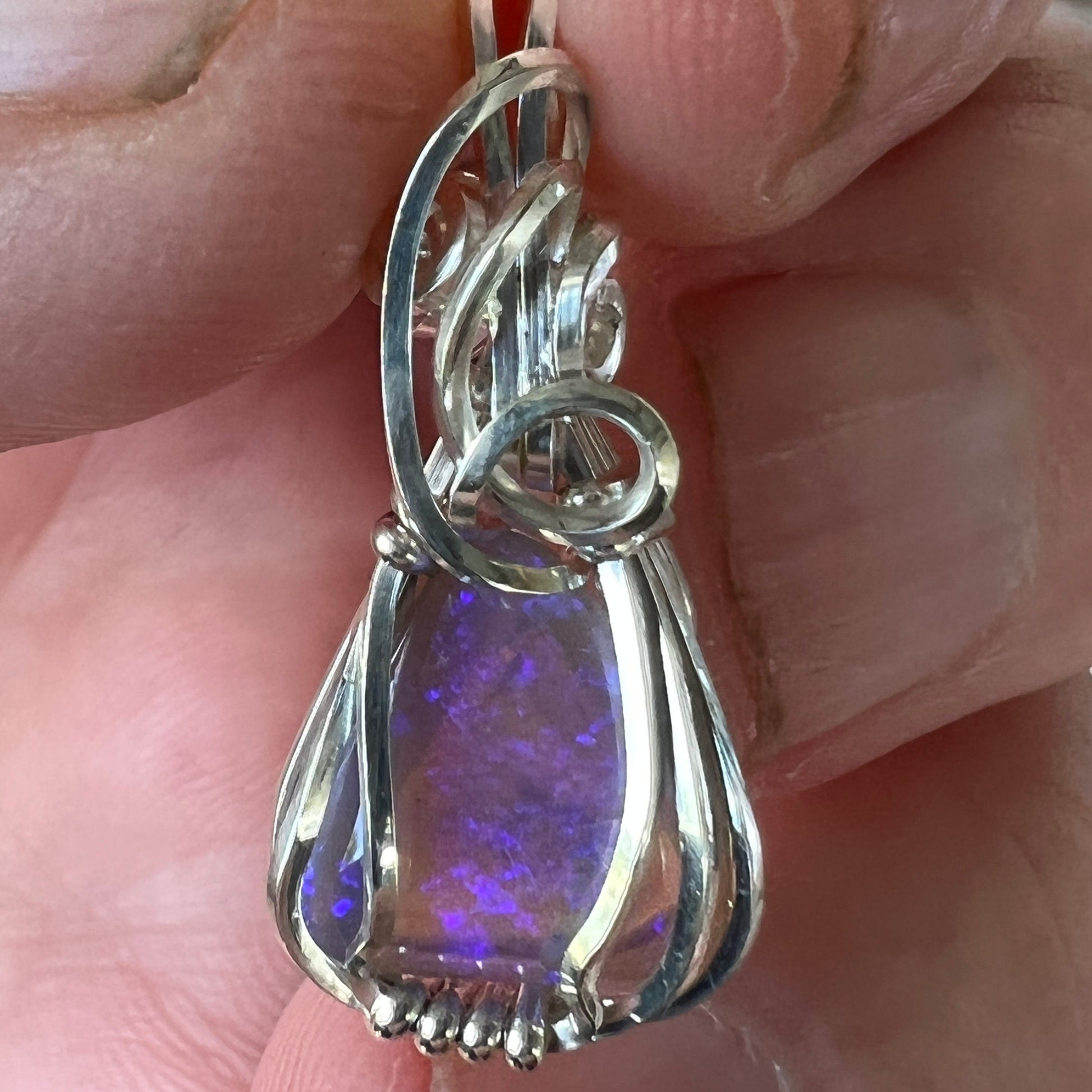 Beautifully cut Lightning Ridge Jelly Crystal opal. Cut and polished by Bill Johnson. Expertly set in a unique wire silver wrap. An awesome hand made gift.