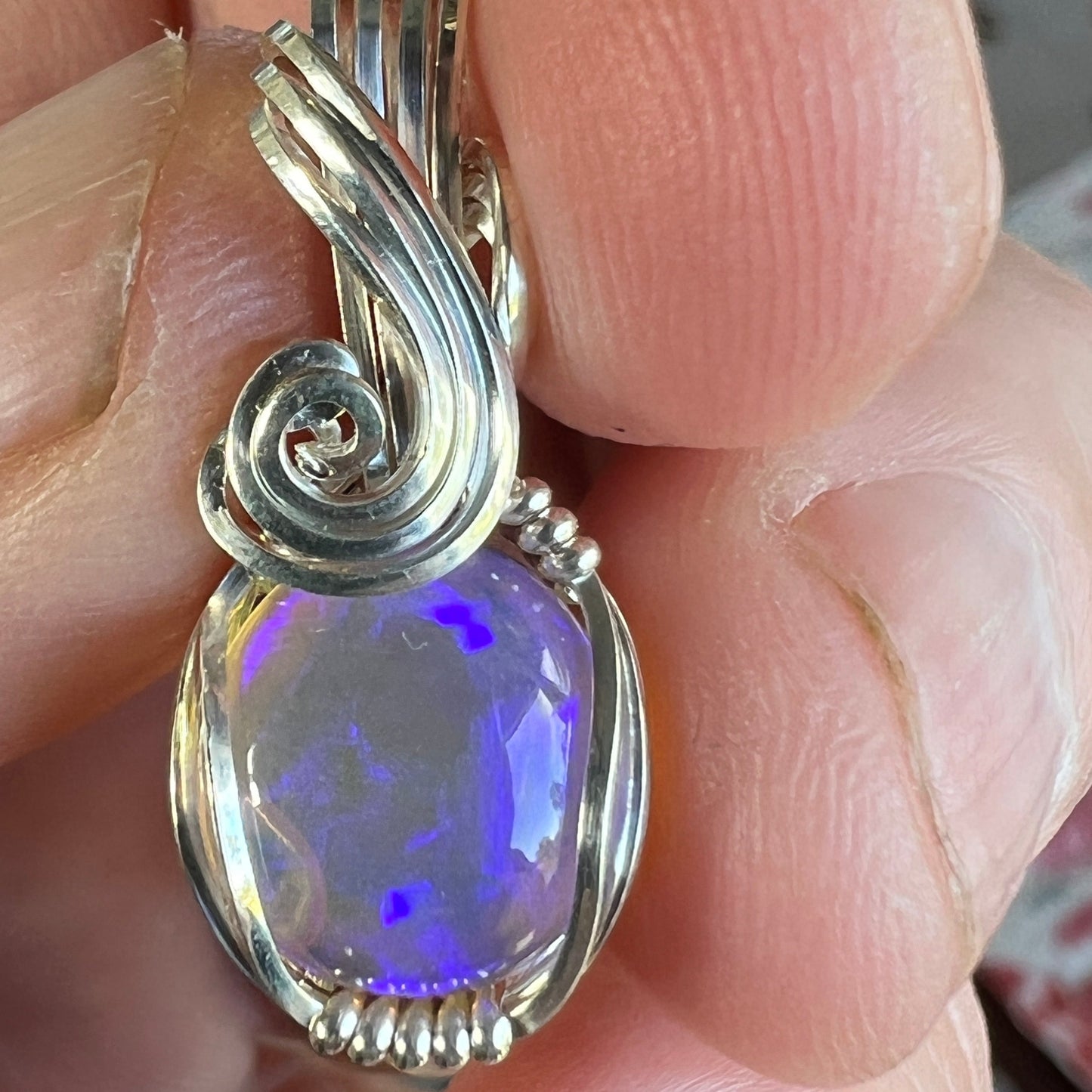 Beautifully cut Lightning Ridge Jelly Crystal opal. Cut and polished by Bill Johnson. Expertly set in a unique silver wire wrap. An awesome hand made gift.