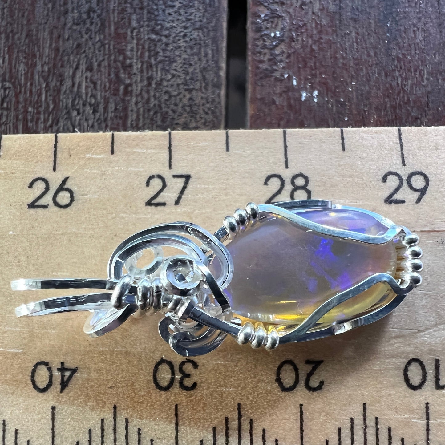 Beautifully cut Lightning Ridge Jelly Crystal opal. Cut and polished by Bill Johnson. Expertly set in a unique silver wire wrap. An awesome hand made gift.