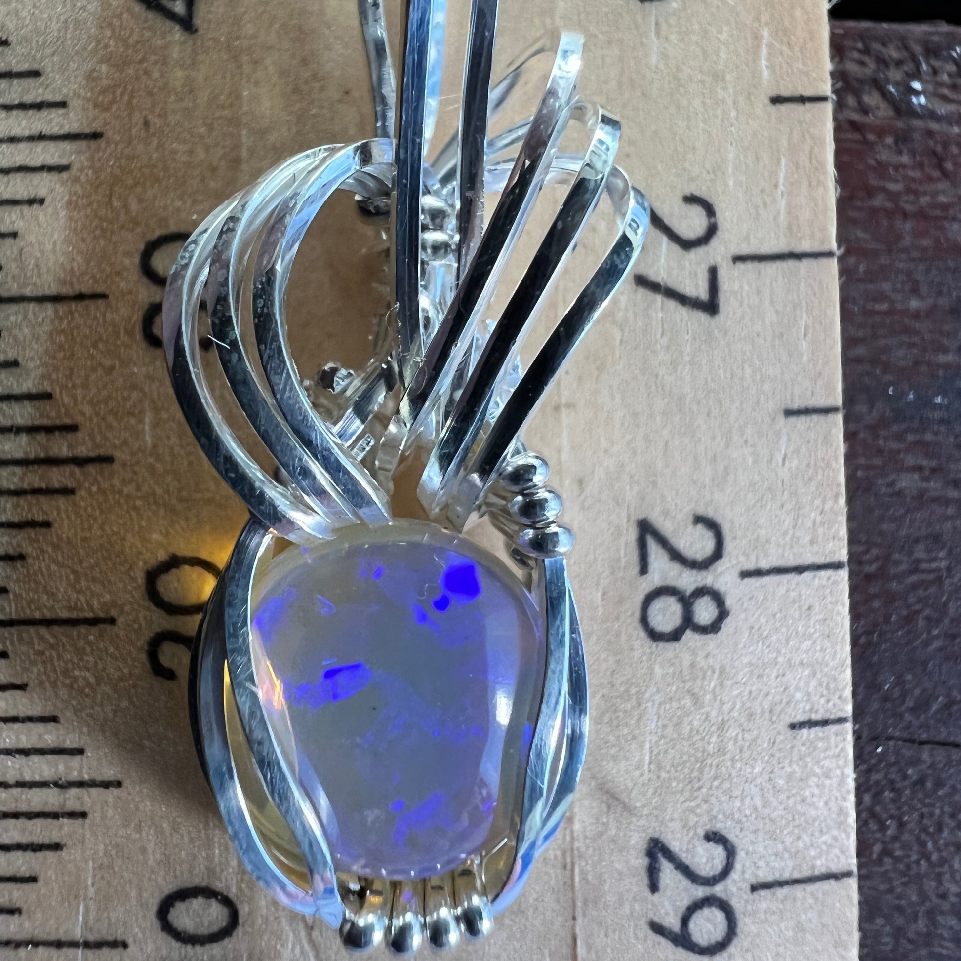Beautifully cut Lightning Ridge Jelly Crystal opal. Cut and polished by Bill Johnson. Expertly set in a unique silver wire wrap. An awesome hand made gift. 