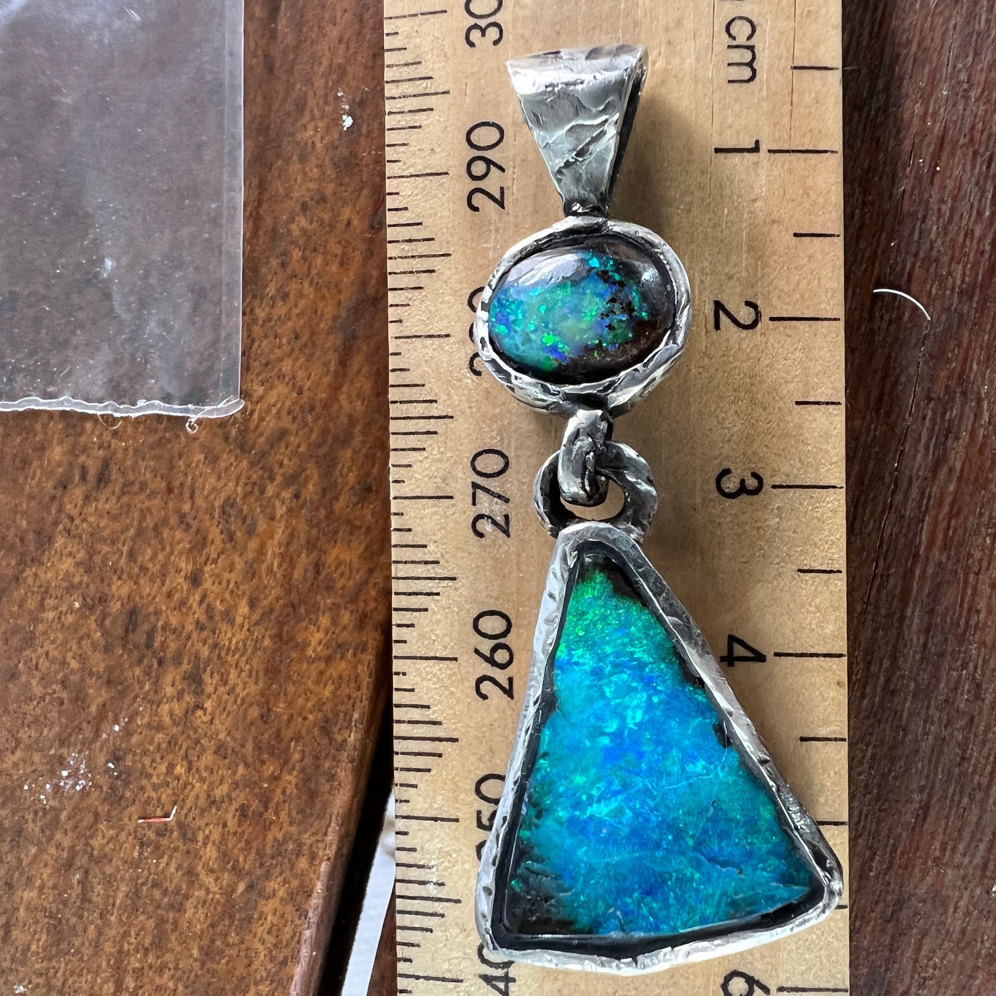 Stunning one-off hand made solid Boulder opal pendant. Hinged between stones to allow movement. Highly textured to enhance rawness.  Made with Argentium silver - a higher silver content using part recycled silver, and a lower allergenic. Crafted by Sally Fisher.