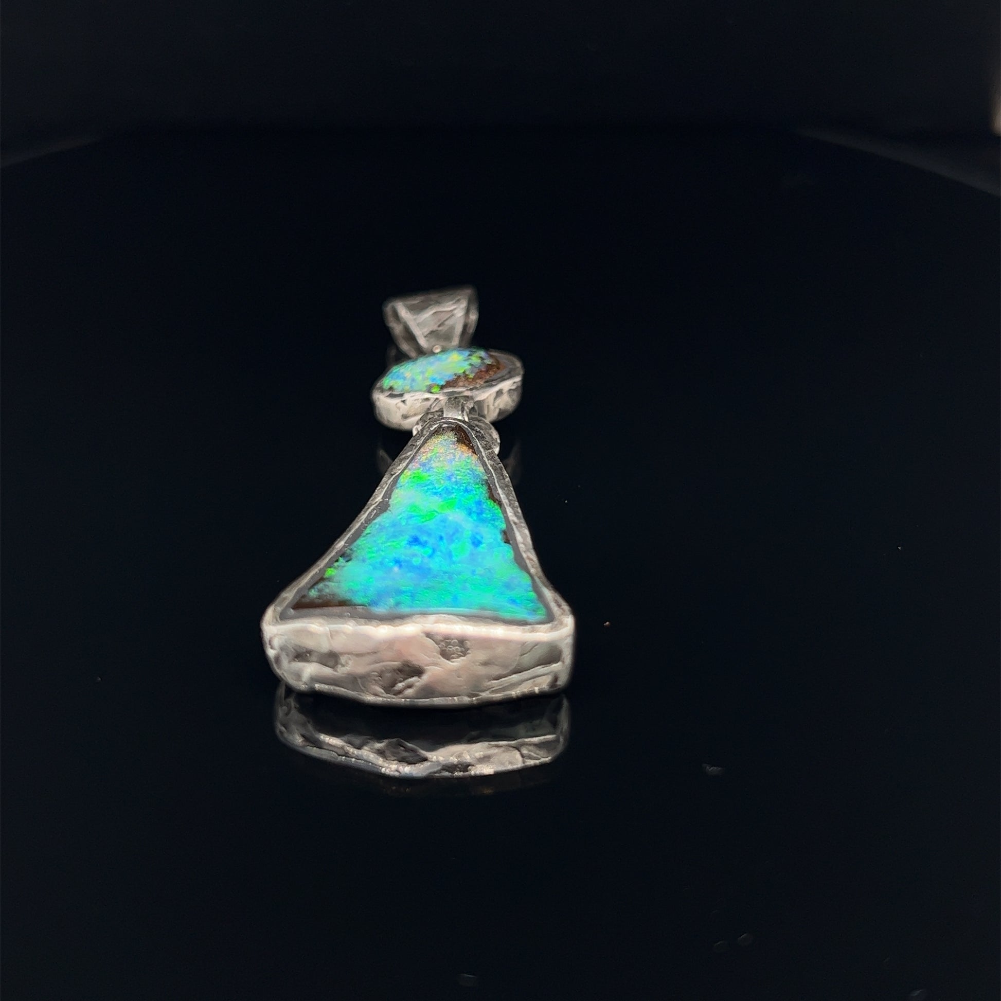 Stunning one-off hand made solid Boulder opal pendant. Hinged between stones to allow movement. Highly textured to enhance rawness. Made with Argentium silver, which has a higher silver content using part recycled silver, and a lower allergenic. Crafted by Sally Fisher.