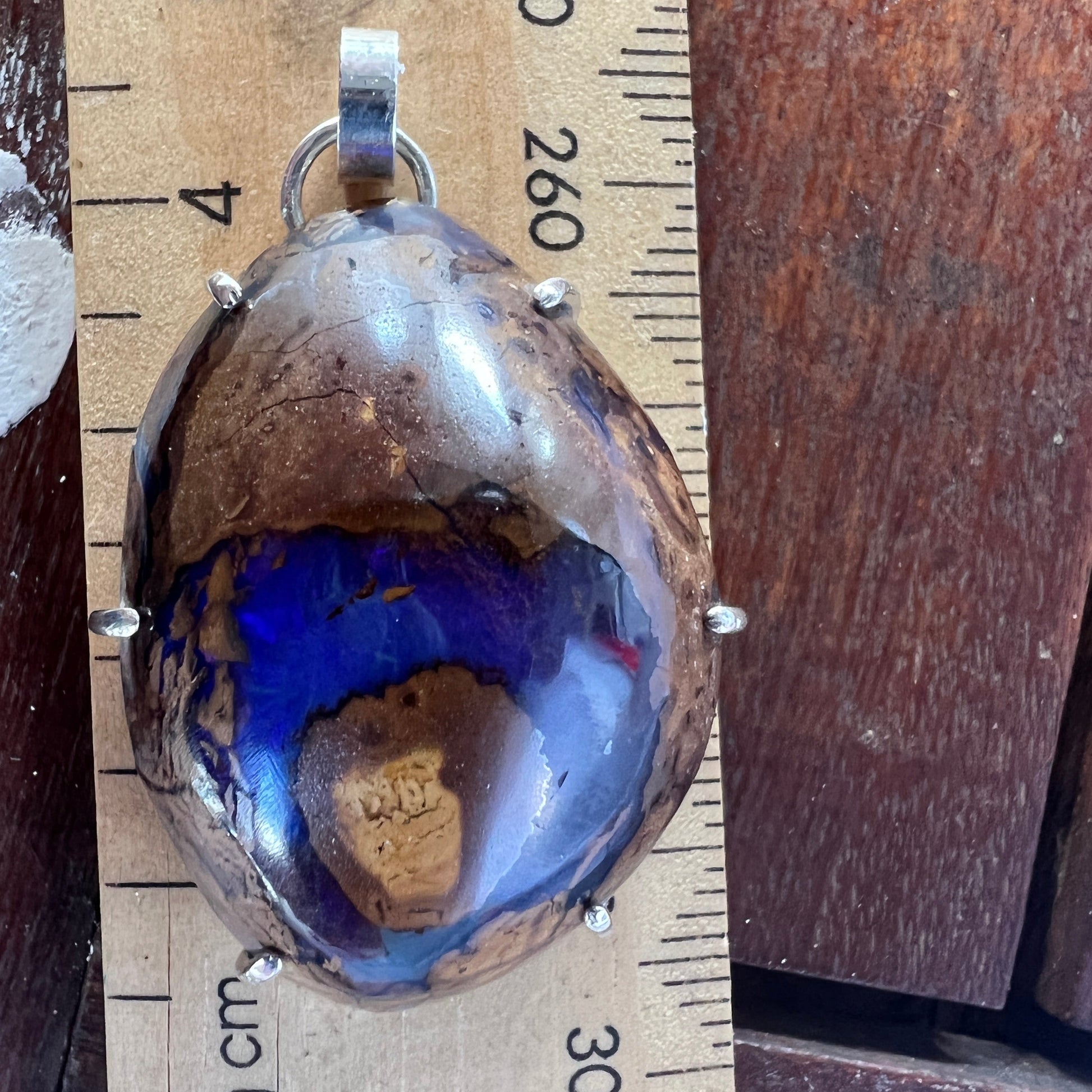 Beautiful example of Winton Boulder opal with an expert polish. Custom made silver mount. A lovely piece.
