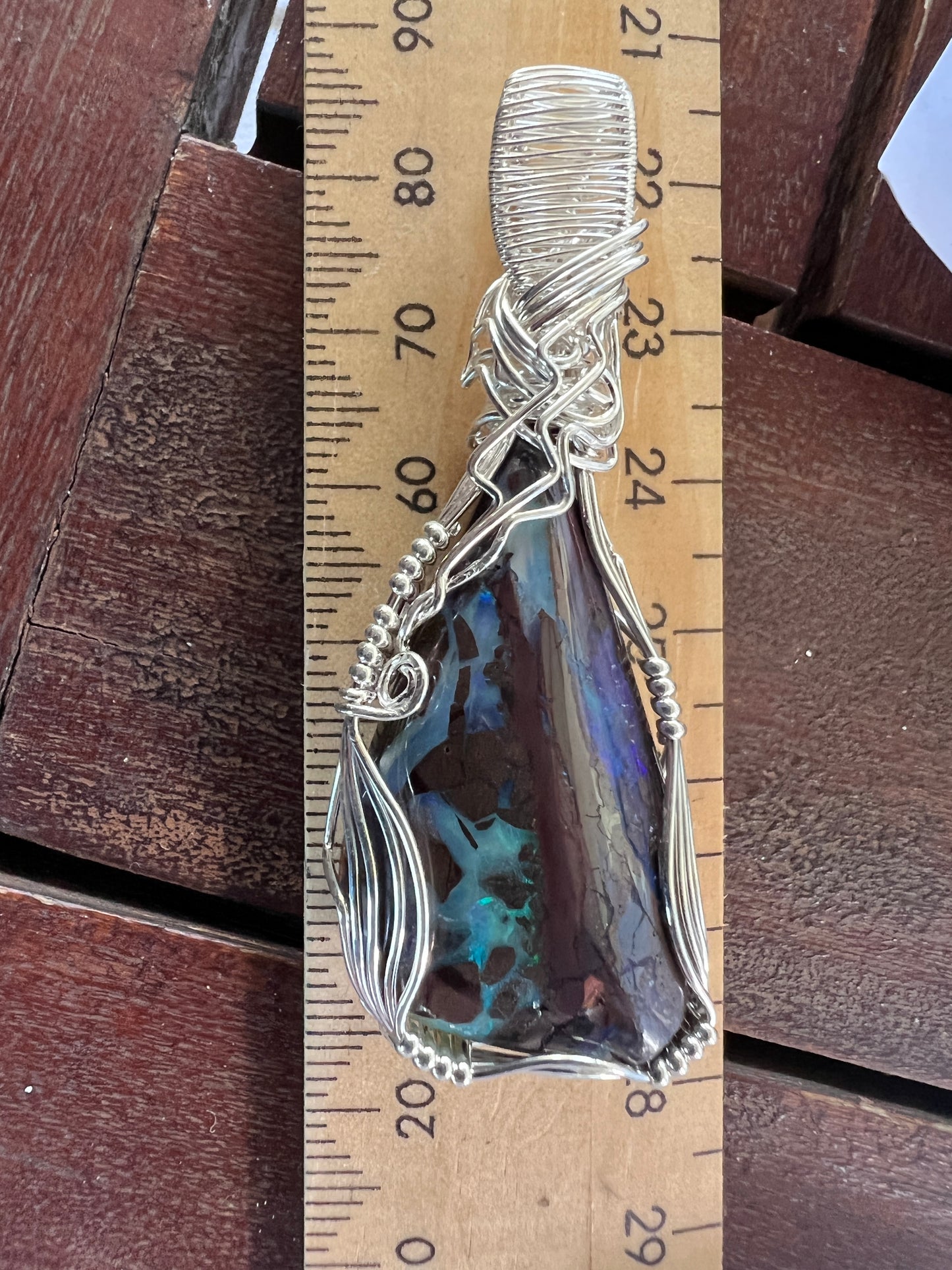 Awesome silver wire wrapped Winton Boulder opal pendant. A great statement piece with lovely colours.