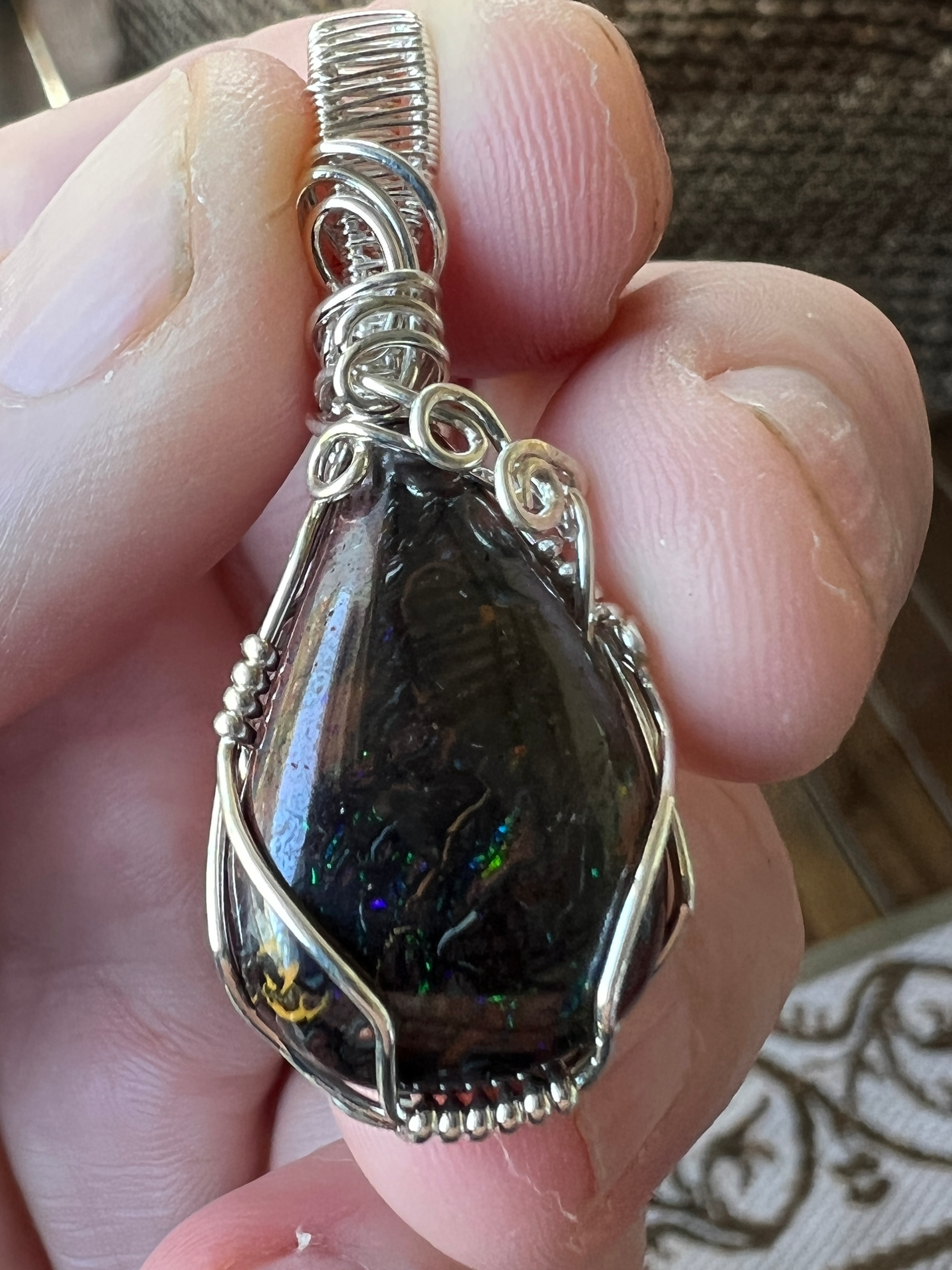 Awesome silver wire wrapped Winton Boulder opal pendant. A great statement piece displaying lovely colours.