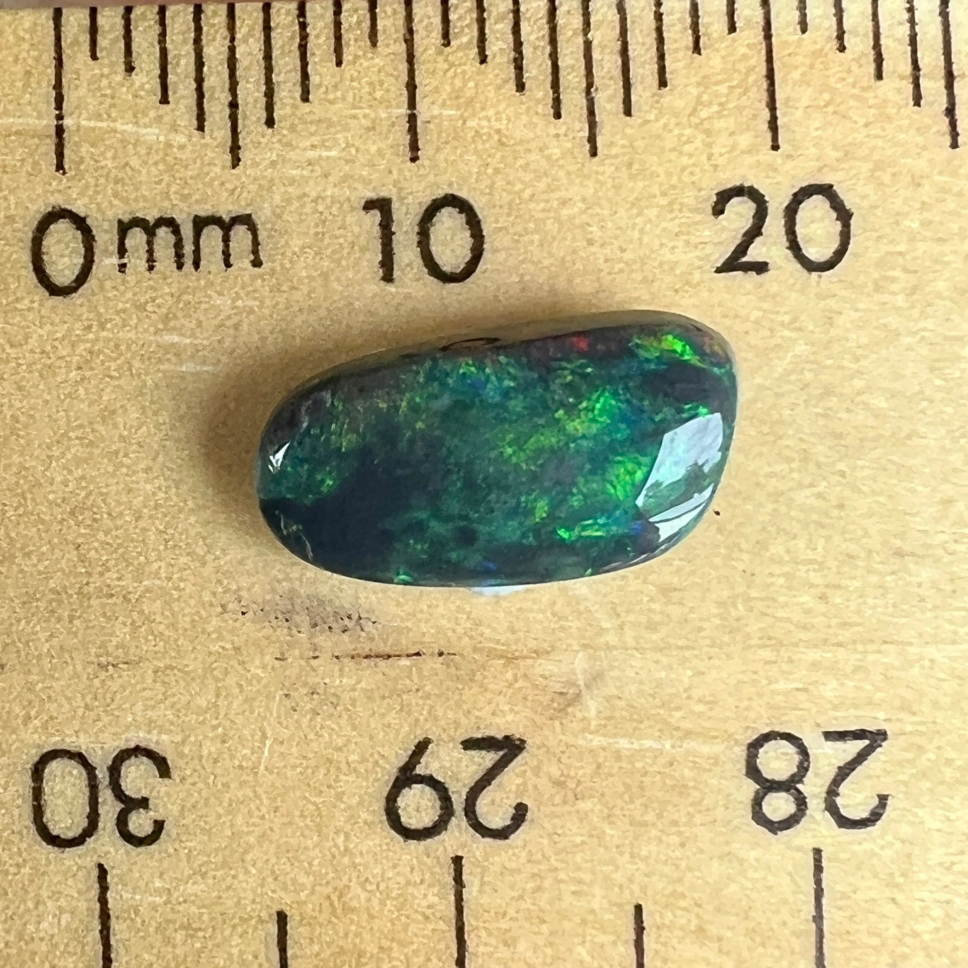 Stunning black opal from the outback opal mines of Lightning Ridge, Beautifully cut and displaying magnificent greens.