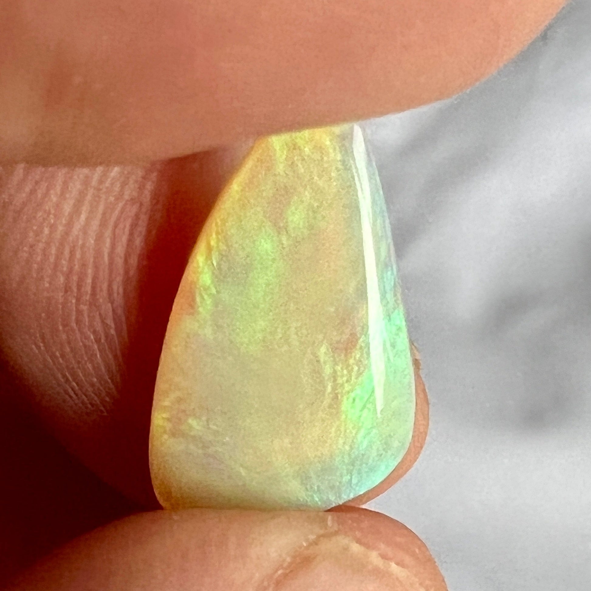 A great example of greens on grey. This Lightning Ridge solid Australian opal is polished to perfection.