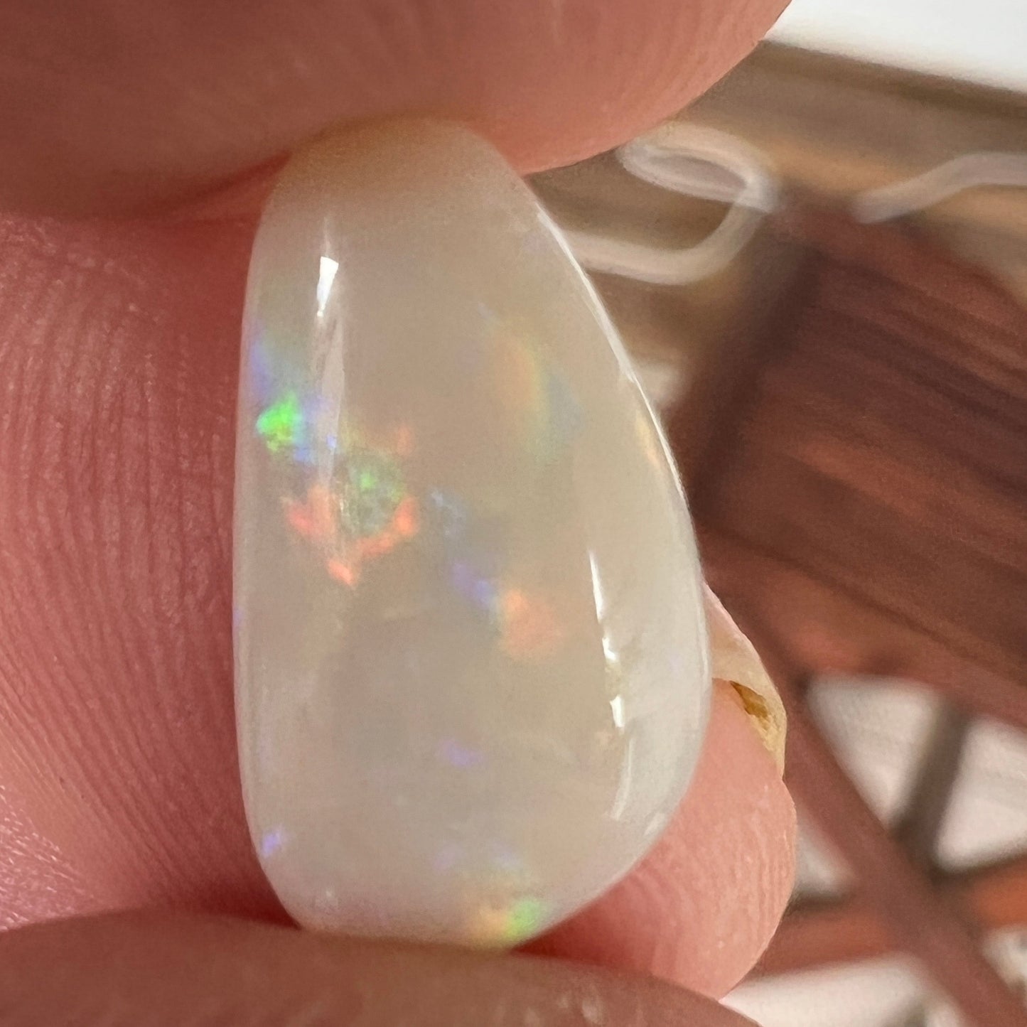 Nice solid white opal from Coober Pedy, displaying rolling flash colours. 