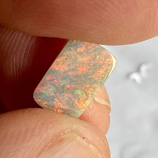 Semi-black opal from Lightning Ridge. A square cut beauty. Great pattern that shows off plenty of reds.