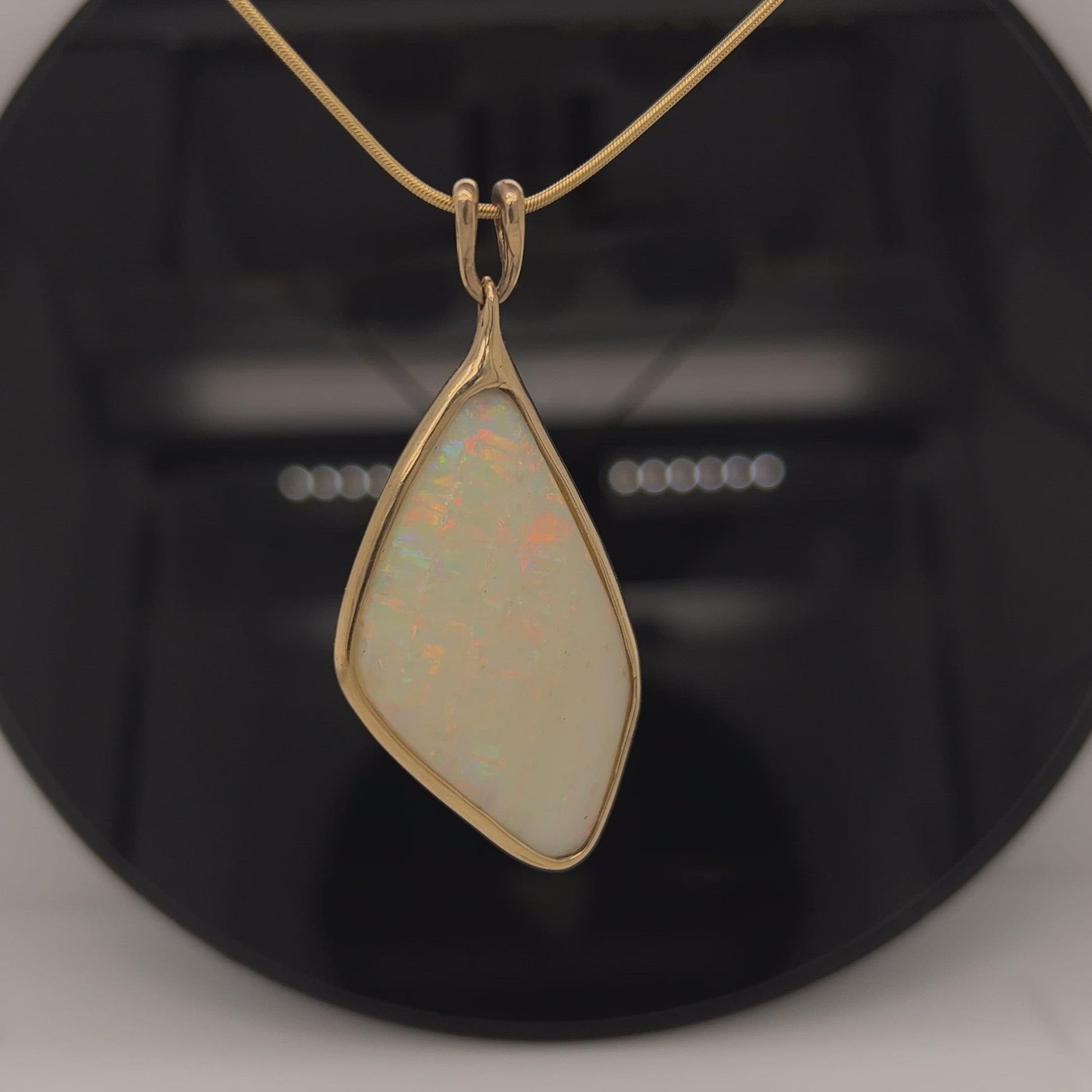 Beautiful solid double sided vertical Mulga opal from the mine of Craig Haxton in Lightning Ridge. Very simple solid 18ct gold setting which enhances the beautiful colours shown in this statement piece.